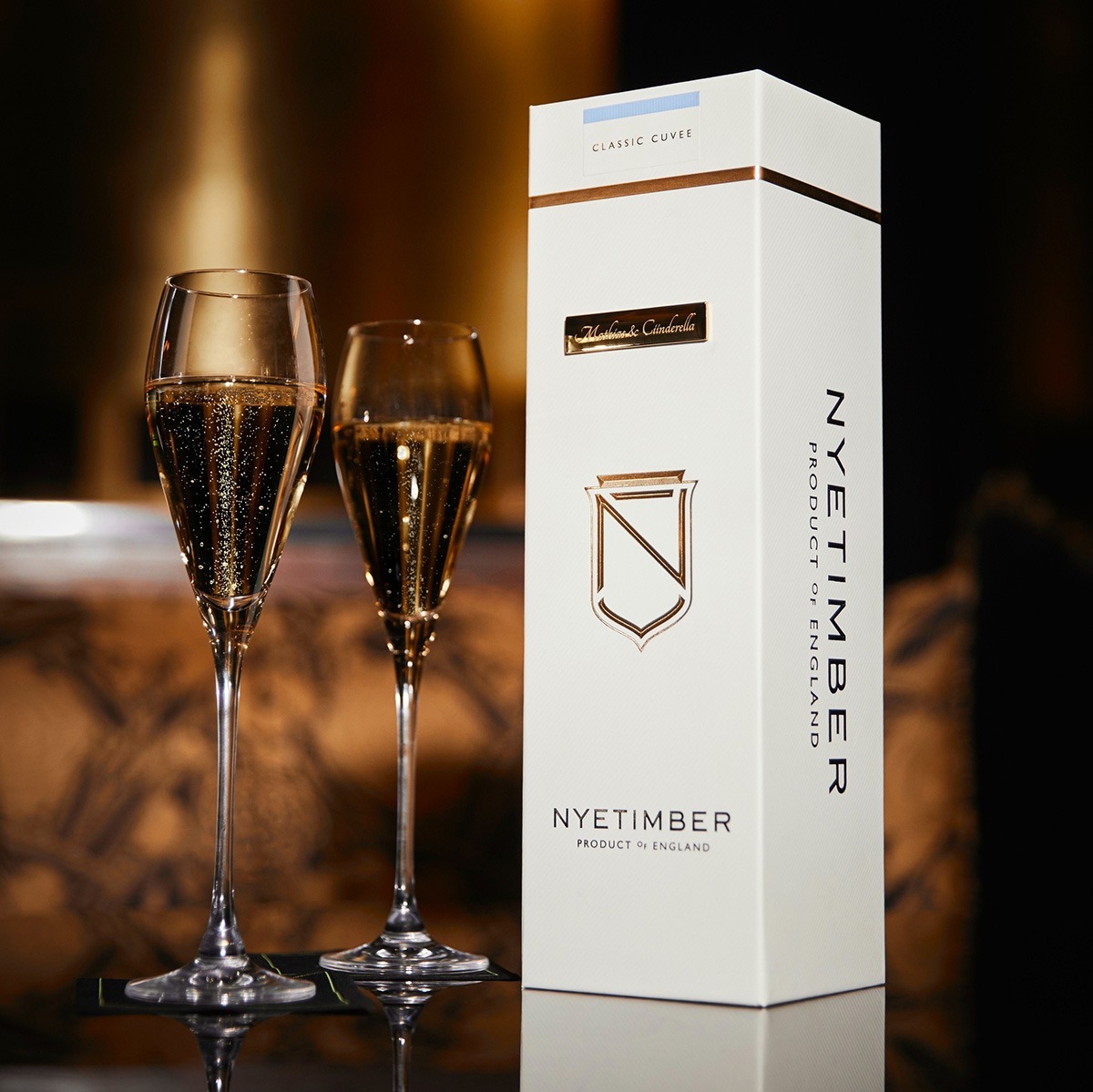 Nyetimber packaging with who glasses of sparkling wine